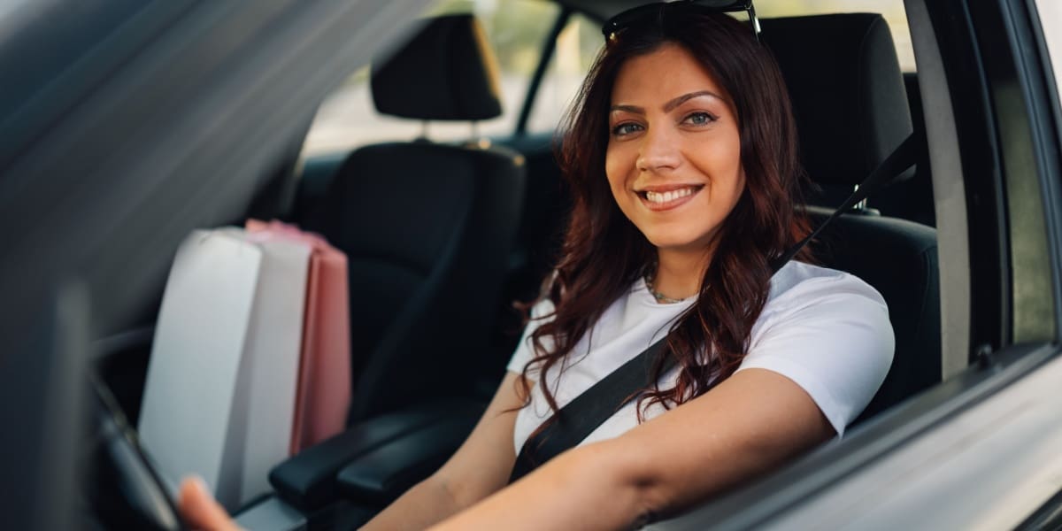 Smiling woman driving a car