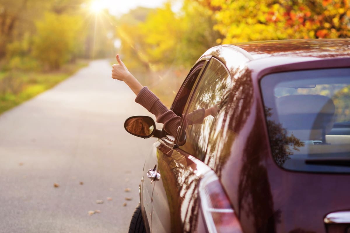 Happy person driving away