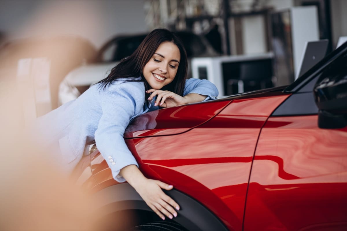 Woman hugging her new car