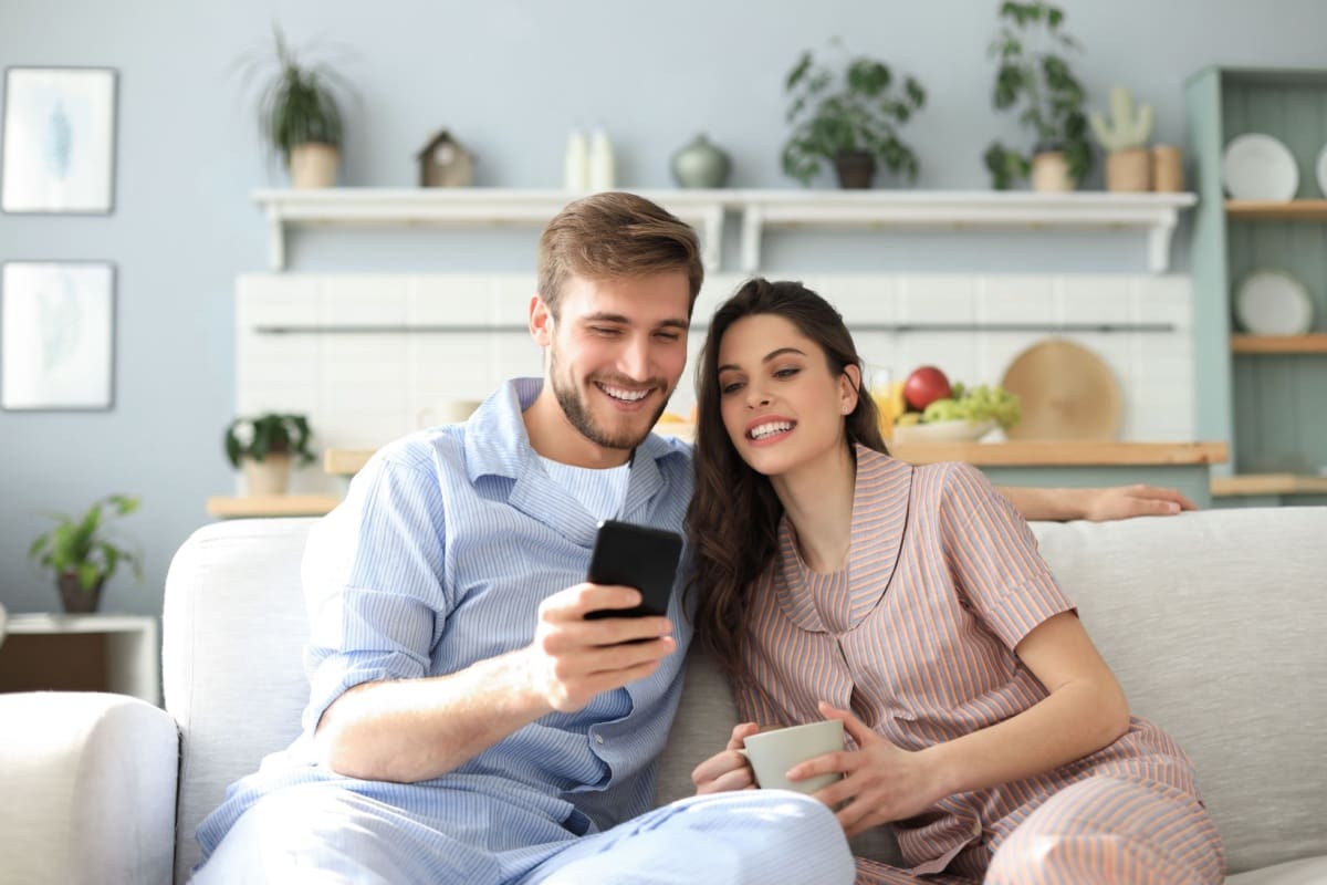 Happy couple looking for renters insurance online