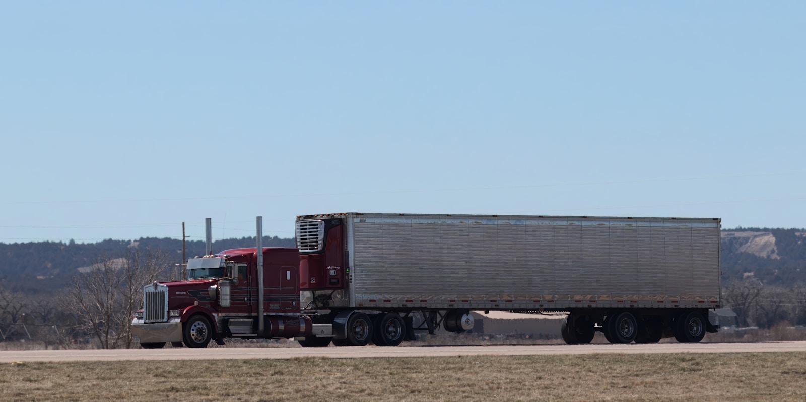 A large semi truck driving down a highway